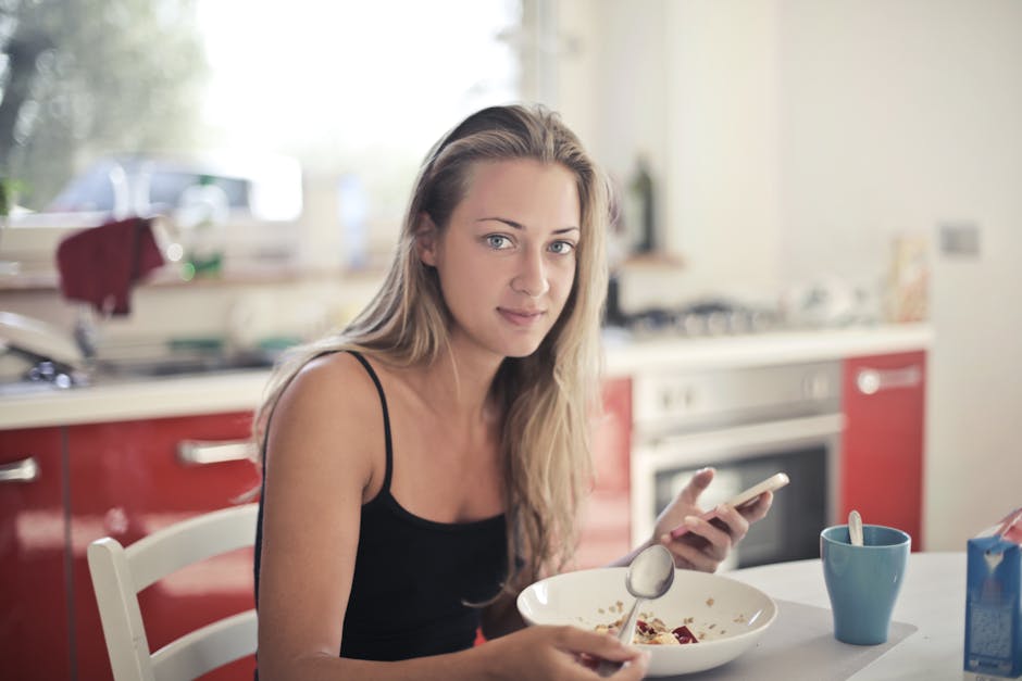 Woman enjoying a healthy breakfast in a modern kitchen, promoting a balanced lif