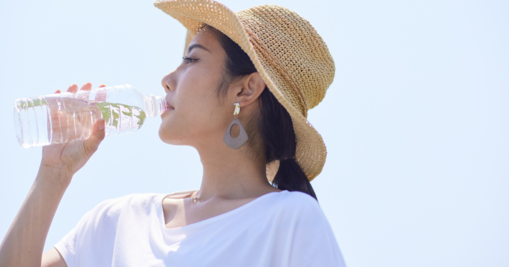 [food_diet] 帽子の女性が水を飲む（人物あり）