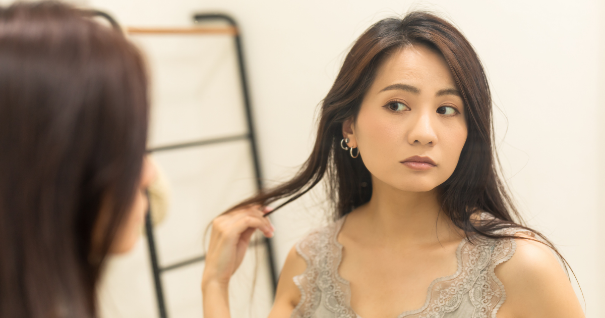 イヤリングをつけて身だしなみを整える女性・骨格タイプに合うアクセサリー選び